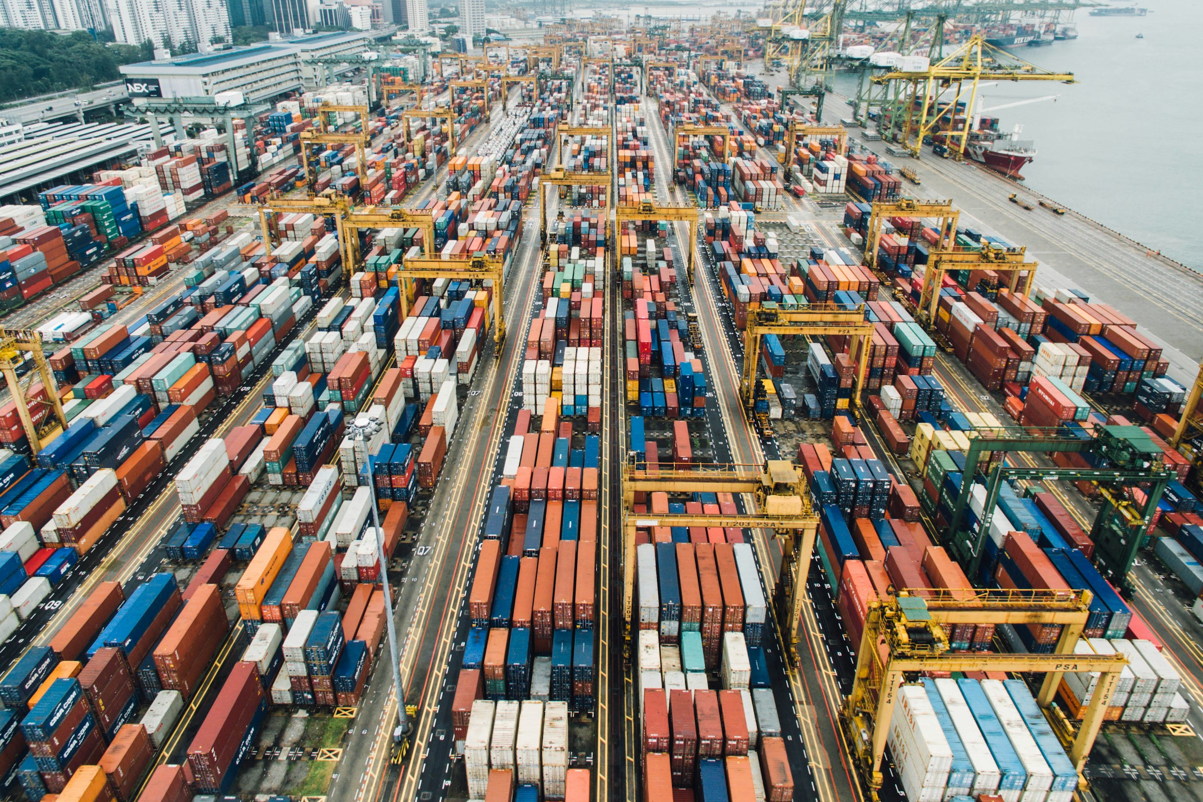 Container port with cranes and stacked shipping containers